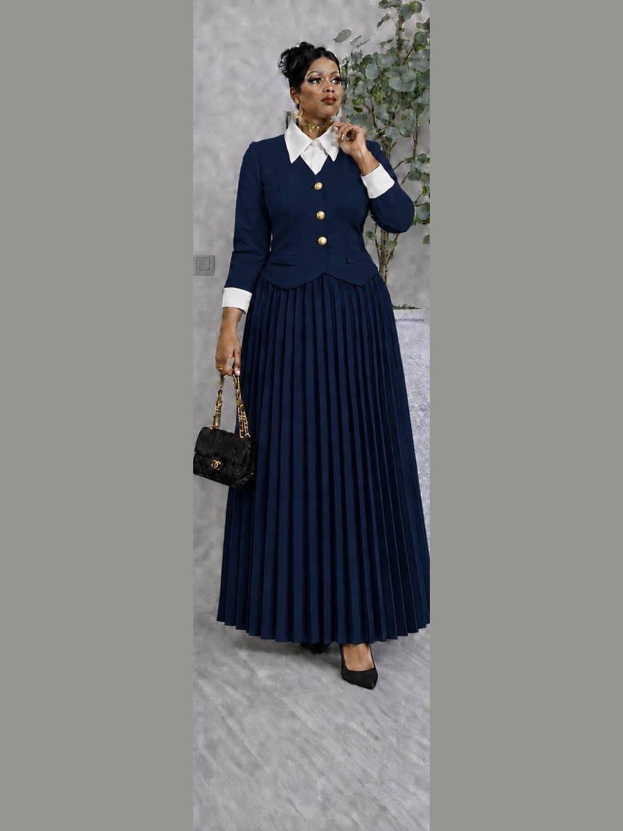 Navy suit with a white collar and a long pleated skirt